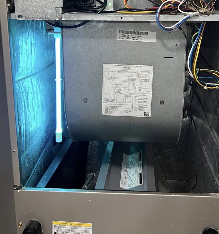 UV light glowing inside an open air handler cabinet